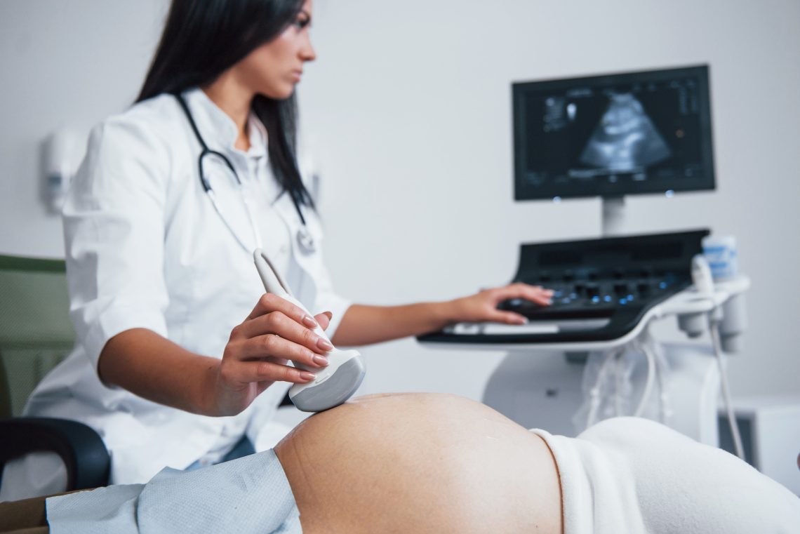 lekarz wykonujący USG kobiecie w ciąży